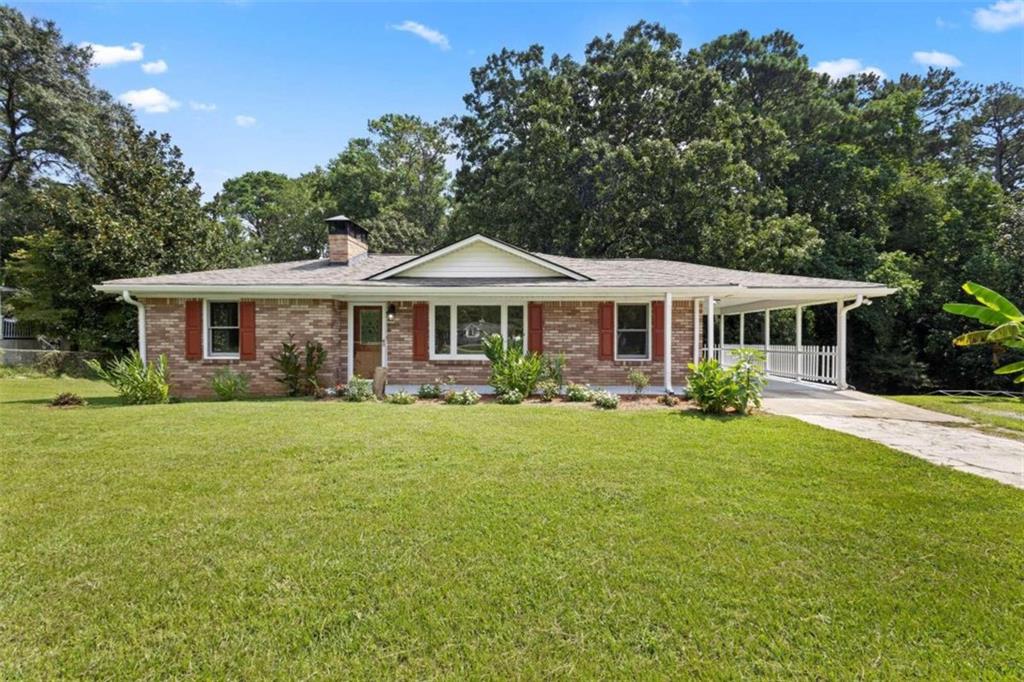 72 Lester Road Lawrenceville, GA 30044 - Photo 1 of 1 a front view of a house with a garden