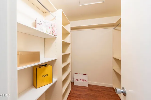 a view of a big room with wooden floor and a ceiling fan