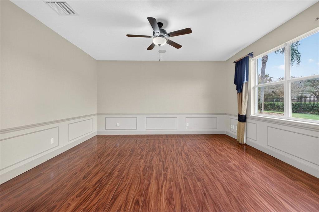 3463 Forest Ridge Lane Kissimmee, FL 34741 - Photo 12 of 58 wooden floor in an empty room with a window