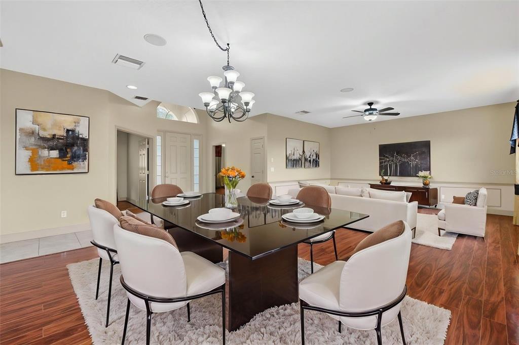3463 Forest Ridge Lane Kissimmee, FL 34741 - Photo 15 of 58 a view of a dining room with furniture wooden floor and chandelier