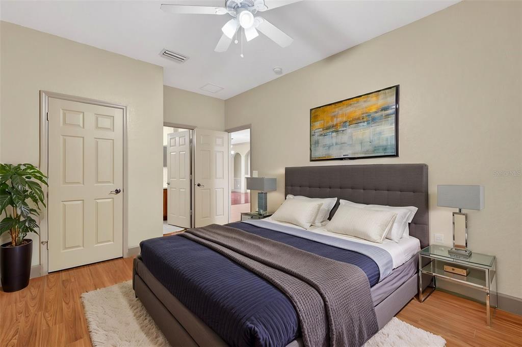 3463 Forest Ridge Lane Kissimmee, FL 34741 - Photo 17 of 58 a bedroom with bed and a potted plant