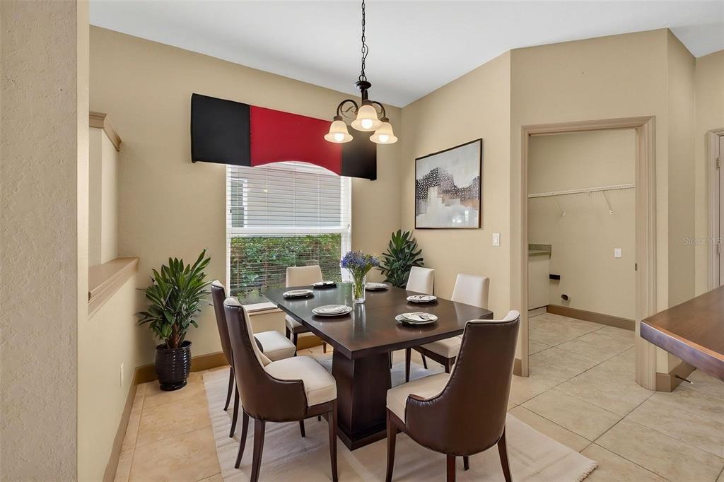 3463 Forest Ridge Lane Kissimmee, FL 34741 - Photo 24 of 58 a dining room with furniture a chandelier and window