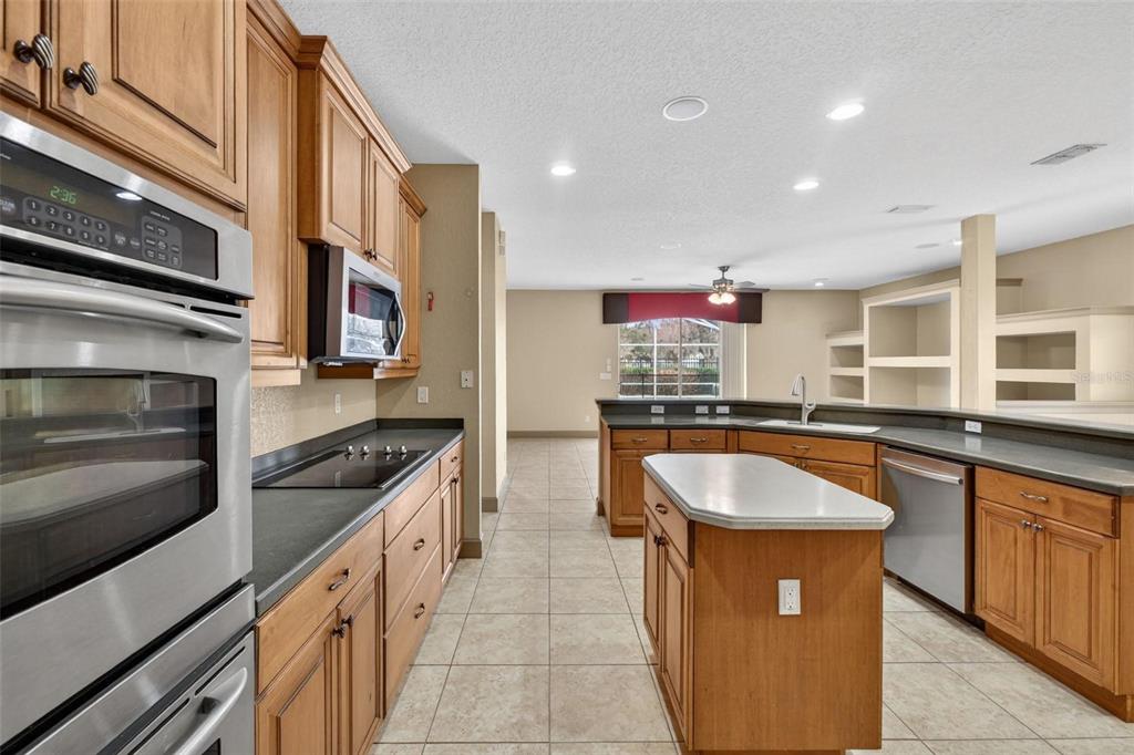 3463 Forest Ridge Lane Kissimmee, FL 34741 - Photo 27 of 58 a kitchen with stainless steel appliances granite countertop a sink and a stove