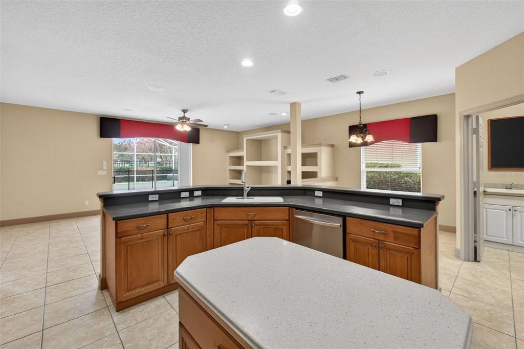 3463 Forest Ridge Lane Kissimmee, FL 34741 - Photo 29 of 58 a kitchen with stainless steel appliances granite countertop a sink counter space cabinets and a large window