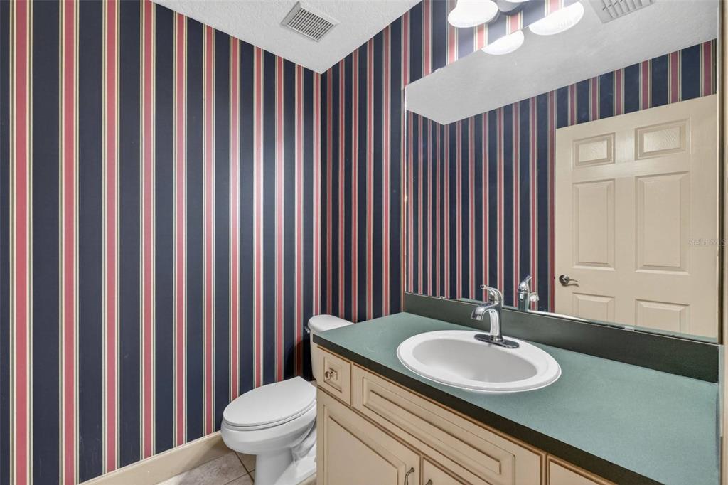 3463 Forest Ridge Lane Kissimmee, FL 34741 - Photo 31 of 58 a bathroom with a toilet a sink and a mirror