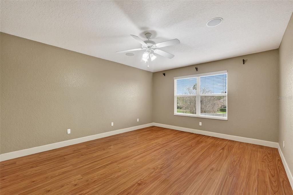 3463 Forest Ridge Lane Kissimmee, FL 34741 - Photo 33 of 58 an empty room with wooden floor and windows