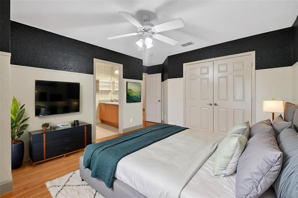 3463 Forest Ridge Lane Kissimmee, FL 34741 - Photo 42 of 58 a bedroom with a bed a television and potted plant