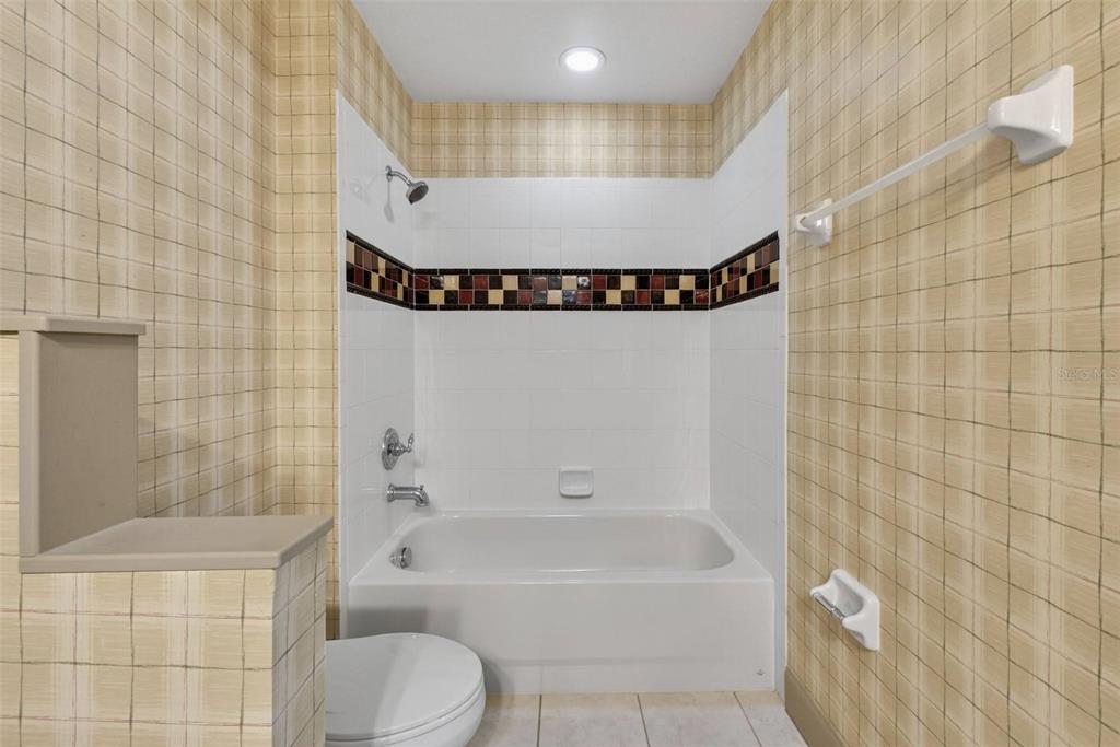 3463 Forest Ridge Lane Kissimmee, FL 34741 - Photo 44 of 58 a bathroom with a bathtub and a shower