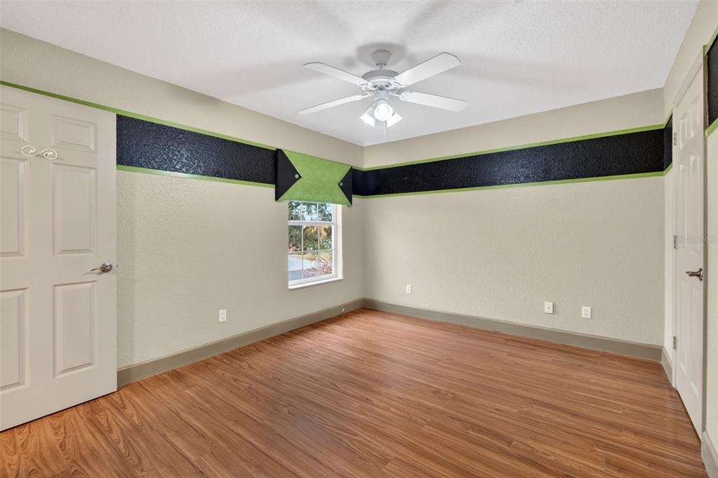 3463 Forest Ridge Lane Kissimmee, FL 34741 - Photo 45 of 58 a view of an empty room with wooden floor and a window