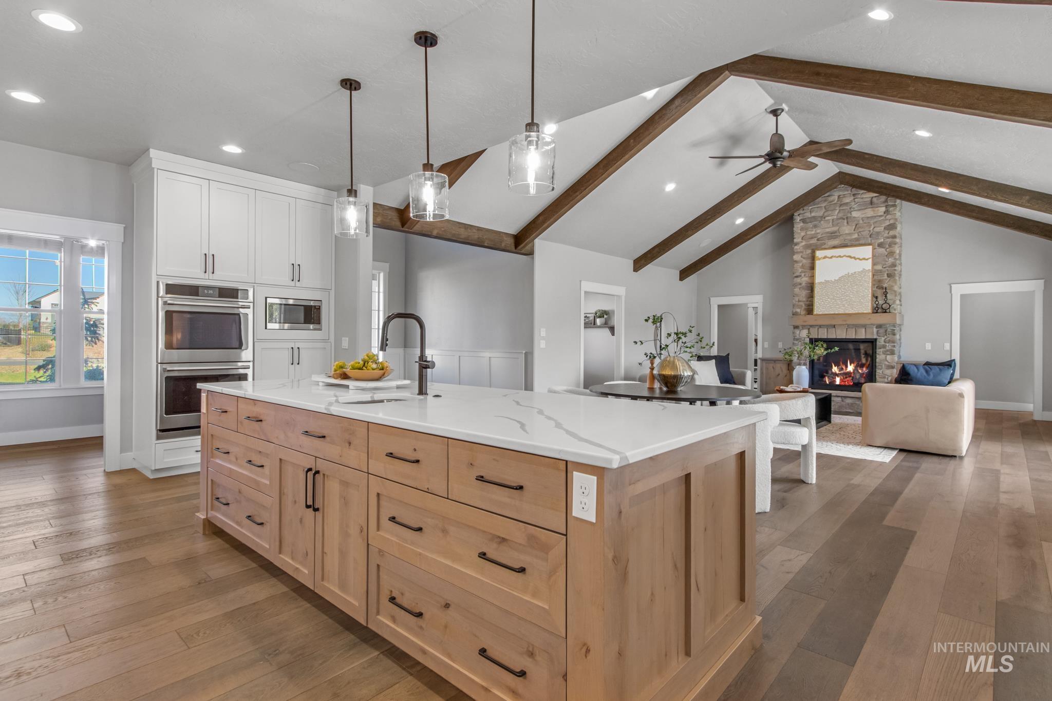 25427 Havard Oak Place Caldwell, ID 83607 - Photo 50 of 50 Kitchen with light wood-type flooring, two tone color scheme, an island with sink, open floor plan, and stainless steel appliances