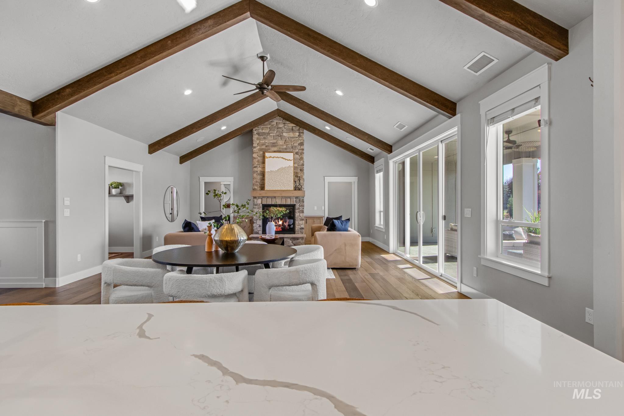 25427 Havard Oak Place Caldwell, ID 83607 - Photo 18 of 50 Dining room with light wood-style floors, a stone fireplace, ceiling fan, and recessed lighting