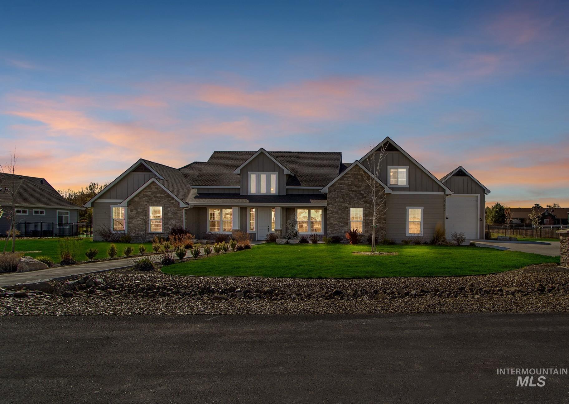 25427 Havard Oak Place Caldwell, ID 83607 - Photo 2 of 50 Craftsman-style home featuring board and batten siding, stone siding, a yard, and a porch