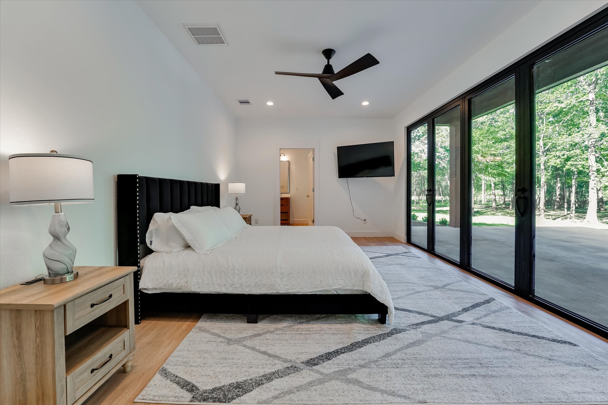 11571 Robin Lane Conroe, TX 77303 - Photo 26 of 49 a bedroom with a large bed and a large window