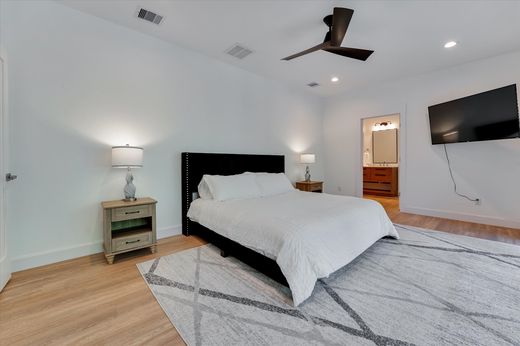 11571 Robin Lane Conroe, TX 77303 - Photo 27 of 49 a bedroom with a bed and a flat screen tv