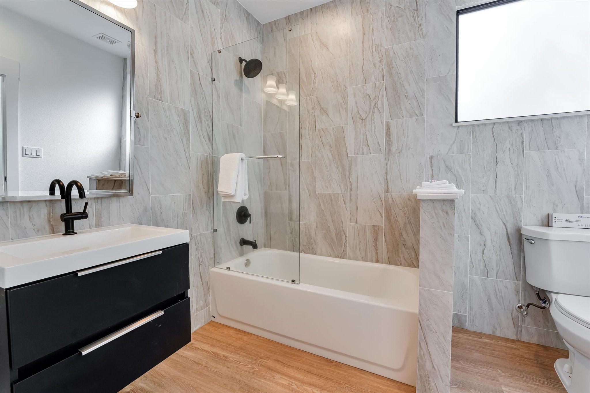 11571 Robin Lane Conroe, TX 77303 - Photo 36 of 49 a bathroom with a bathtub a sink and a toilet