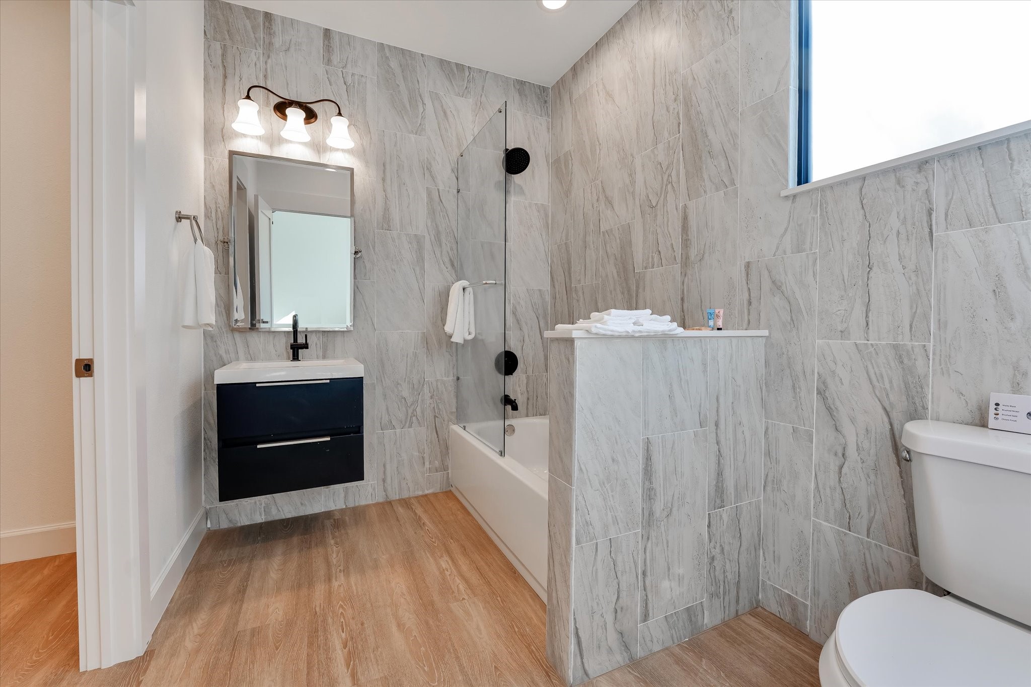 11571 Robin Lane Conroe, TX 77303 - Photo 37 of 49 a bathroom with a sink a toilet a mirror and shower