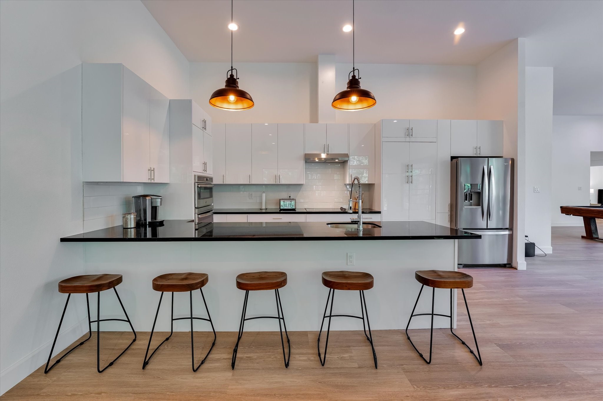 11571 Robin Lane Conroe, TX 77303 - Photo 4 of 49 a kitchen with stainless steel appliances a dining table chairs microwave and sink