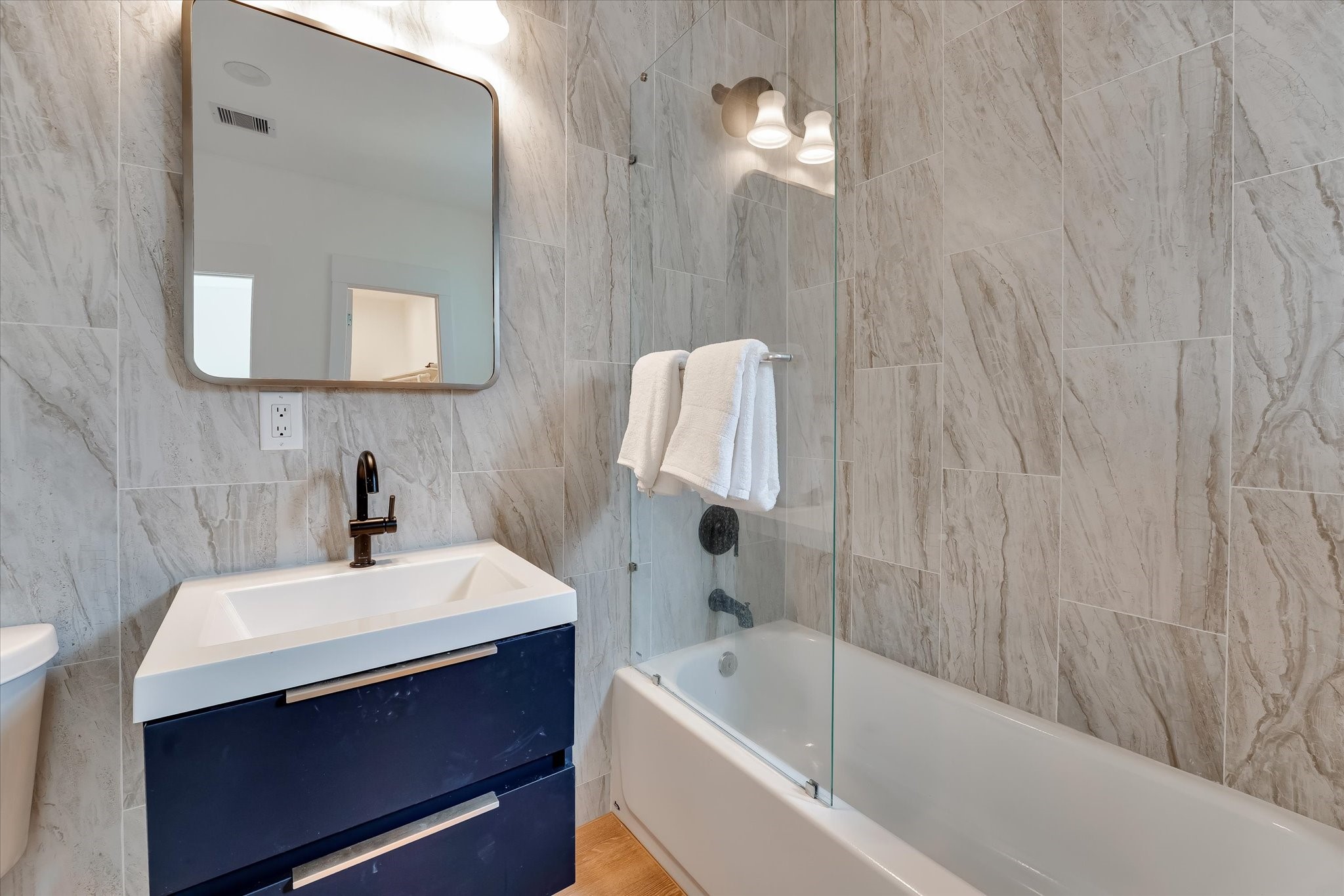 11571 Robin Lane Conroe, TX 77303 - Photo 42 of 49 a bathroom with a sink a bathtub and a mirror