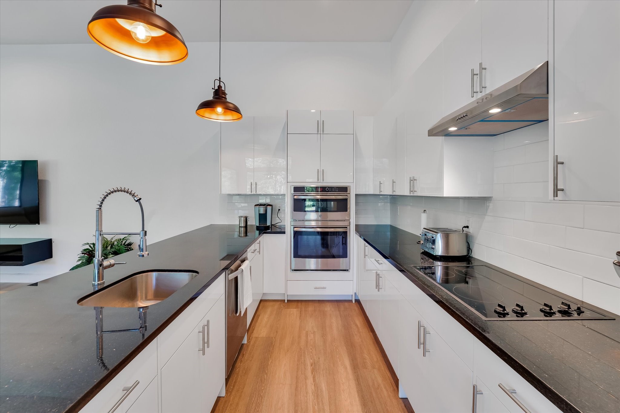 11571 Robin Lane Conroe, TX 77303 - Photo 5 of 49 a kitchen with kitchen island stainless steel appliances a sink a stove and a wooden floors