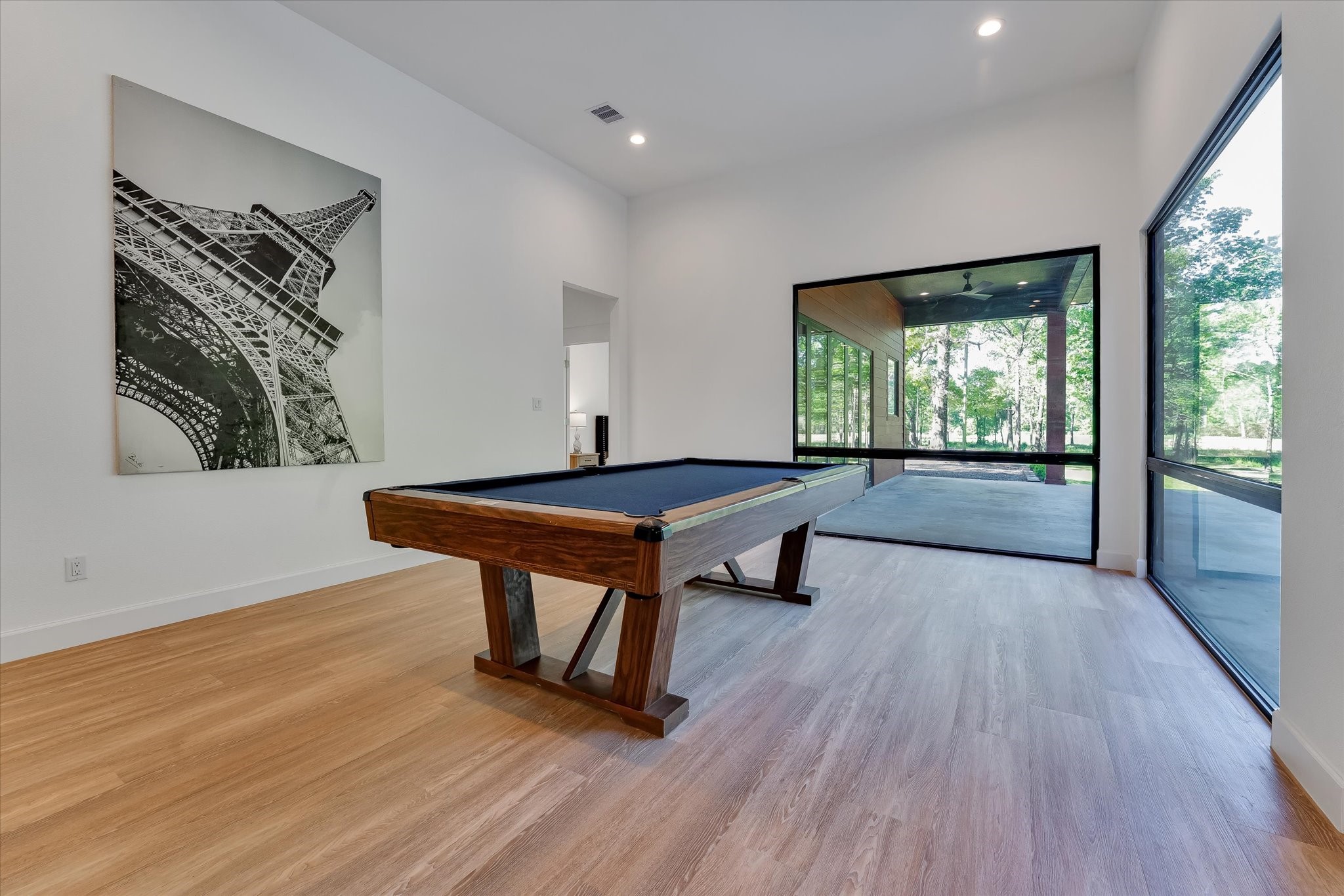 11571 Robin Lane Conroe, TX 77303 - Photo 10 of 49 a room with wooden floor table and chairs