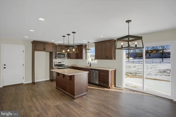 a kitchen with stainless steel appliances granite countertop a stove and a refrigerator