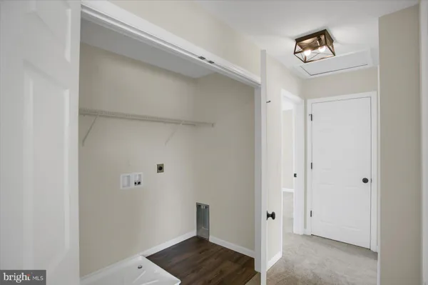 a view of a room with wooden floor and cabinet