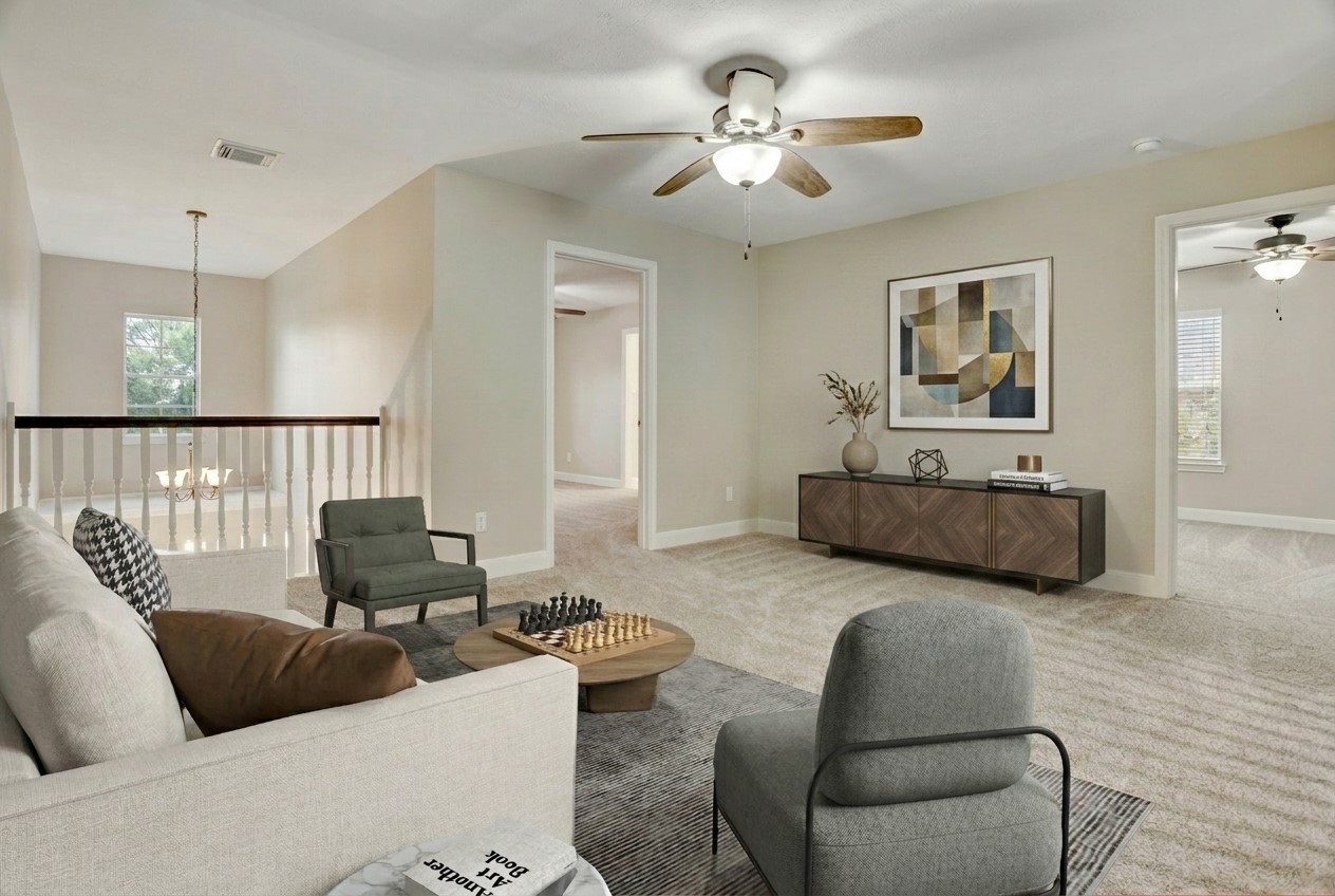 24418 Falcon Point Drive Katy, TX 77494 - Photo 21 of 40 a living room with furniture ceiling fan and a rug