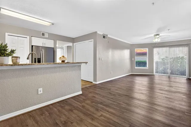 a view of a kitchen with wooden floor and a window