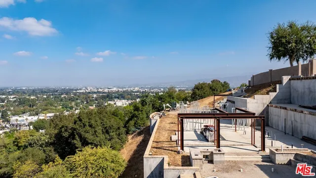 a view of a backyard with sitting area