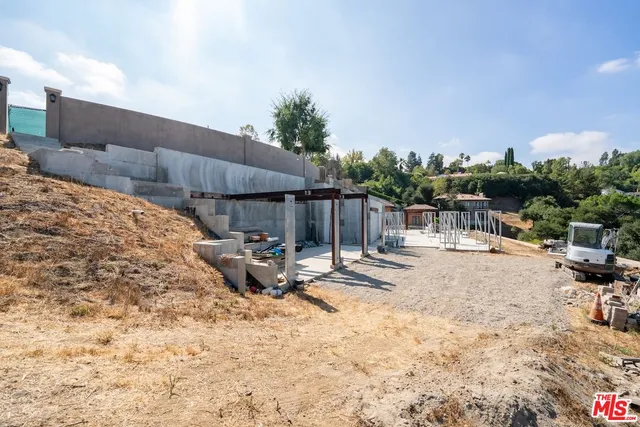a view of a porch with furniture and a yard