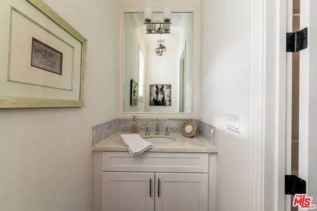 a kitchen with a sink cabinets stainless steel appliances and a window