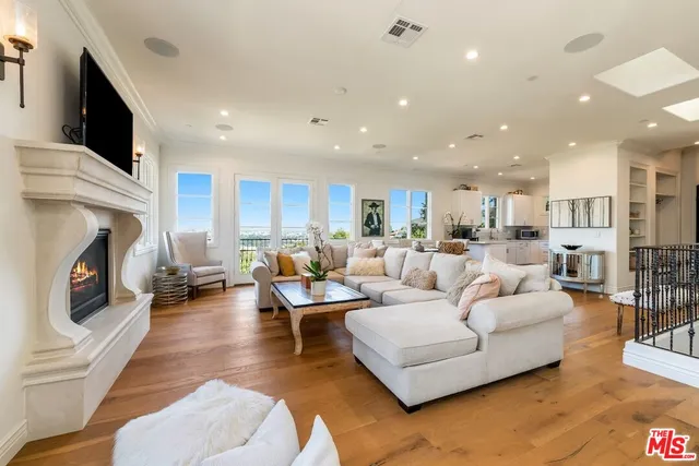 a dining room with furniture and a wooden floor