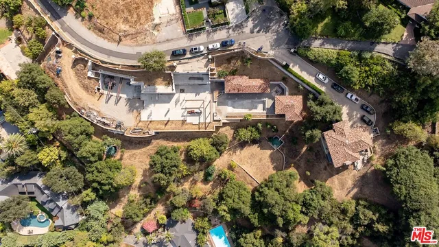 an aerial view of a house with a garden and plants