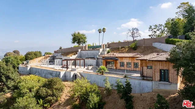 an aerial view of a house with lake swimming pool and outdoor seating