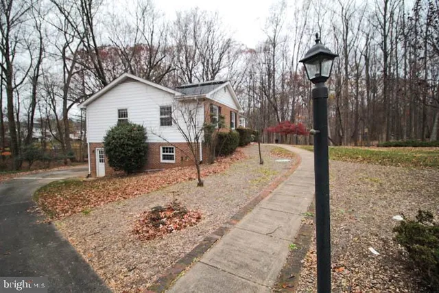 a view of a house with a yard covered in snow