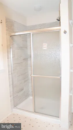 a bathroom with a glass shower door