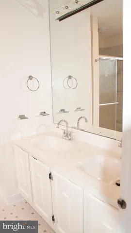 a bathroom with a shower and a sink
