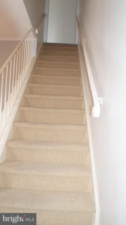 a view of staircase with white walls