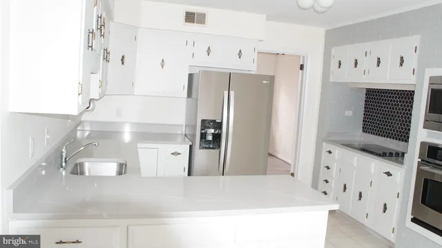 a kitchen with stainless steel appliances a refrigerator and a stove