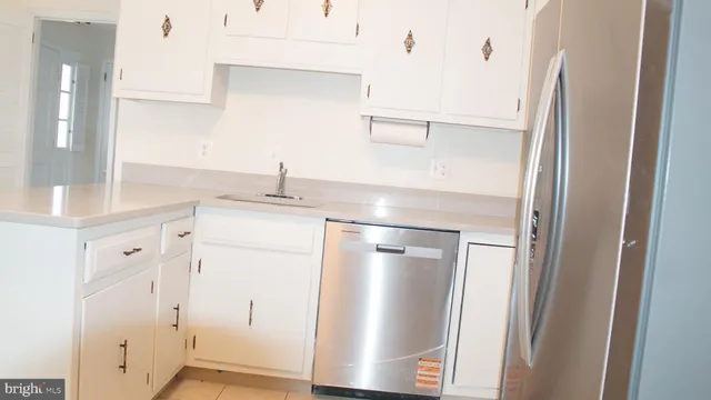 a kitchen with a refrigerator and a sink