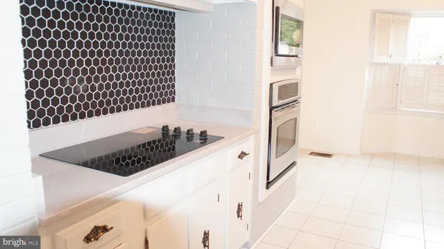 a view of a kitchen counter space and windows