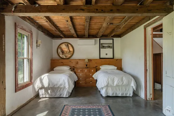 a bedroom with bed and a large mirror