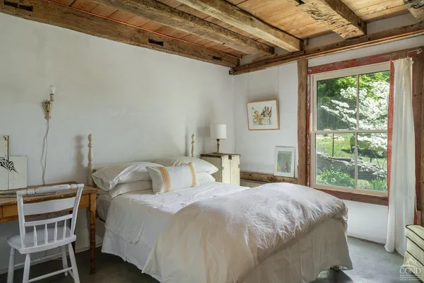 a bedroom with a bed and a window