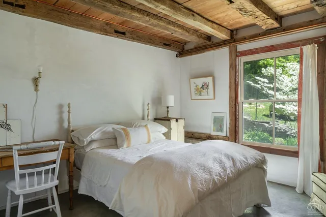 a bedroom with a bed and a window