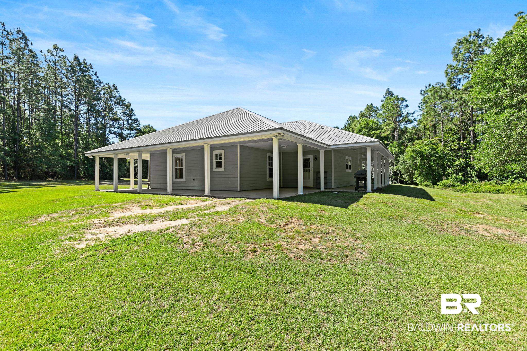 20219 Greek Cemetery Road Robertsdale, AL 36567 - Photo 6 of 41 Ranch-style residence featuring a metal roof and light grey siding