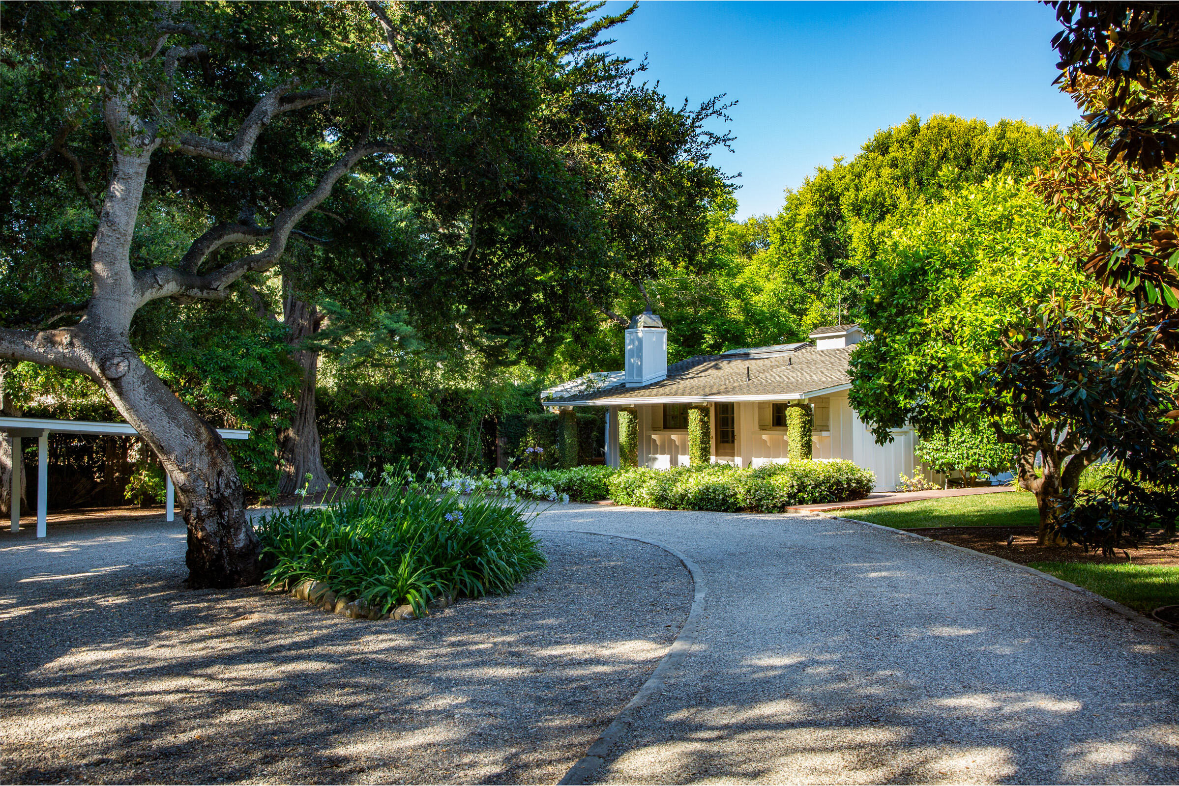 279 Santa Rosa Lane Montecito, CA 93108 - Photo 24 of 27 a front view of a house with a yard and a garage