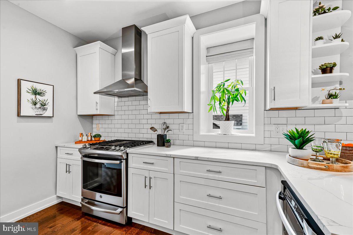 308 Chestnut Avenue Narberth, PA 19072 - Photo 20 of 66 a kitchen with stainless steel appliances white cabinets a stove a sink a potted plant and wooden floor
