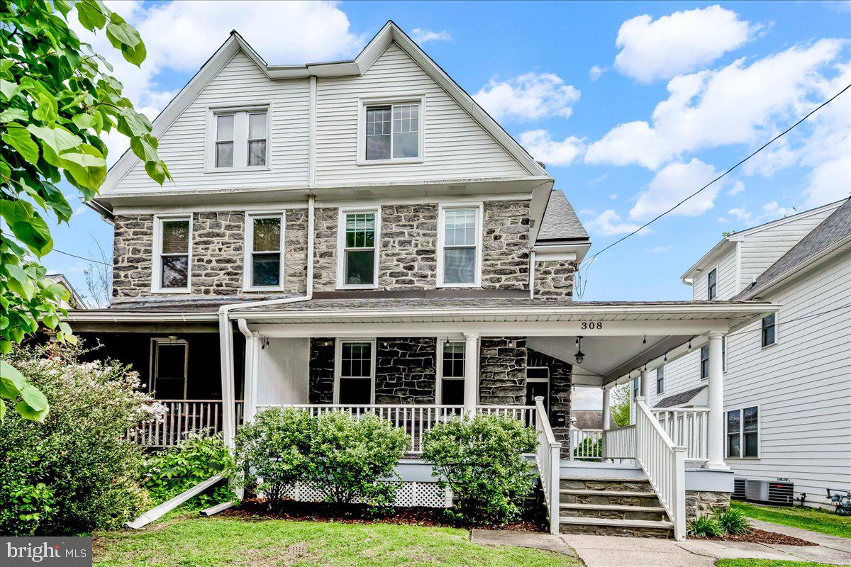 308 Chestnut Avenue Narberth, PA 19072 - Photo 2 of 66 a view of a white house with large windows and a yard with plants and large trees