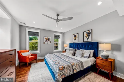 a bedroom with furniture and a flat screen tv