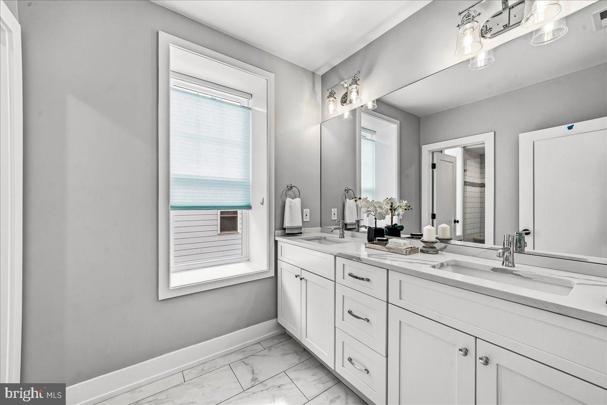 308 Chestnut Avenue Narberth, PA 19072 - Photo 30 of 66 a bathroom with a double vanity sink and a mirror